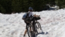 Mary Metcalf-Collier pushes her bike in snow while racing in Tour Divide in 2008. She was the first woman to race and complete the 2,711-mile route along the Continental Divide. Photo credit: "Ride the Divide"